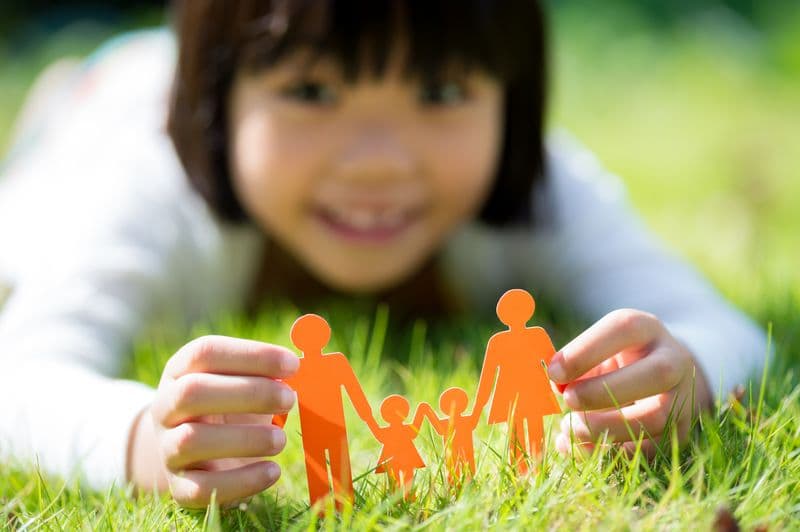 Asian girl with orange paper family